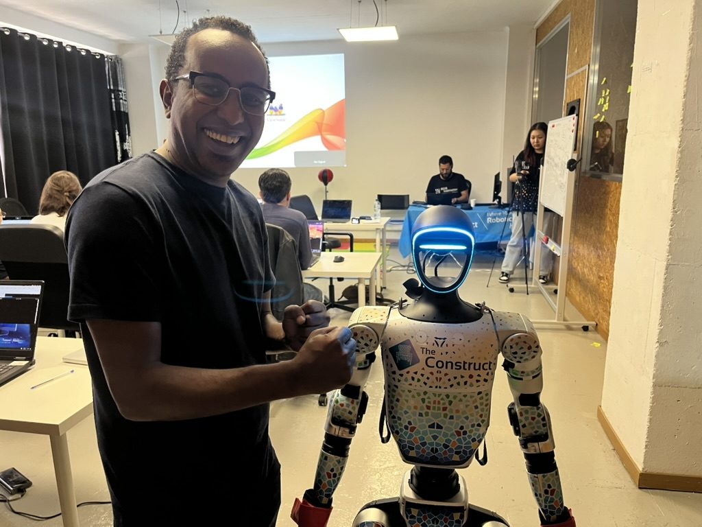 Mohamed Omar with a Unitree G1 humanoid robot at The Construct Robotics Institute, Barcelona